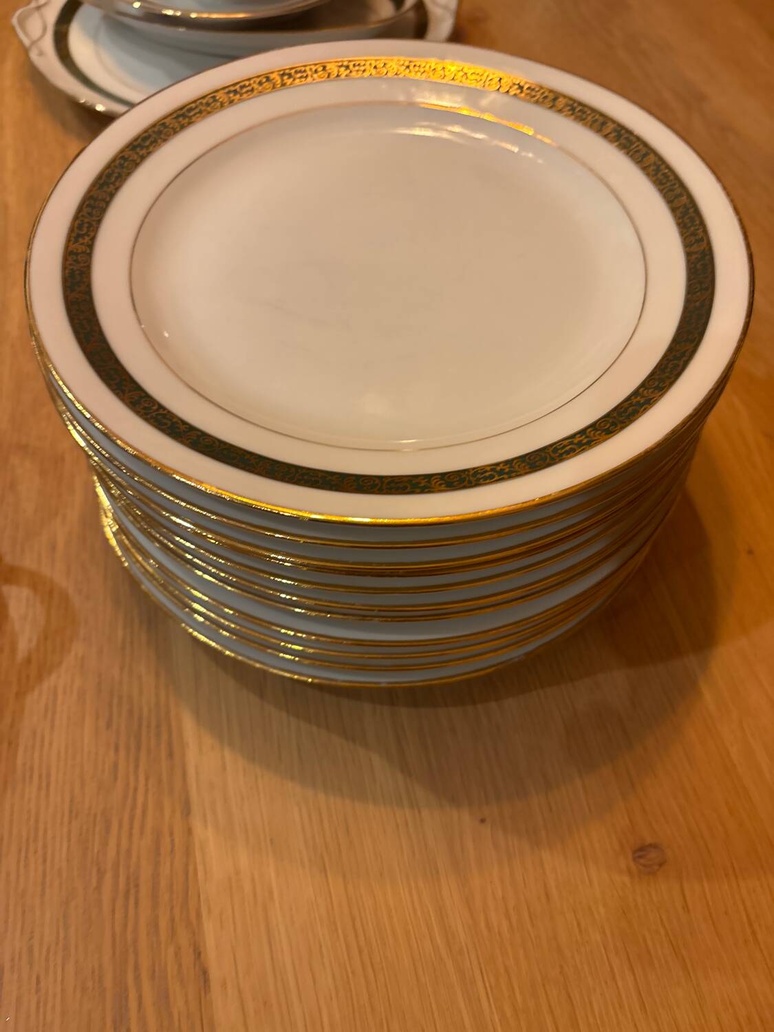 Complete old service in green and gold Limoges porcelain.