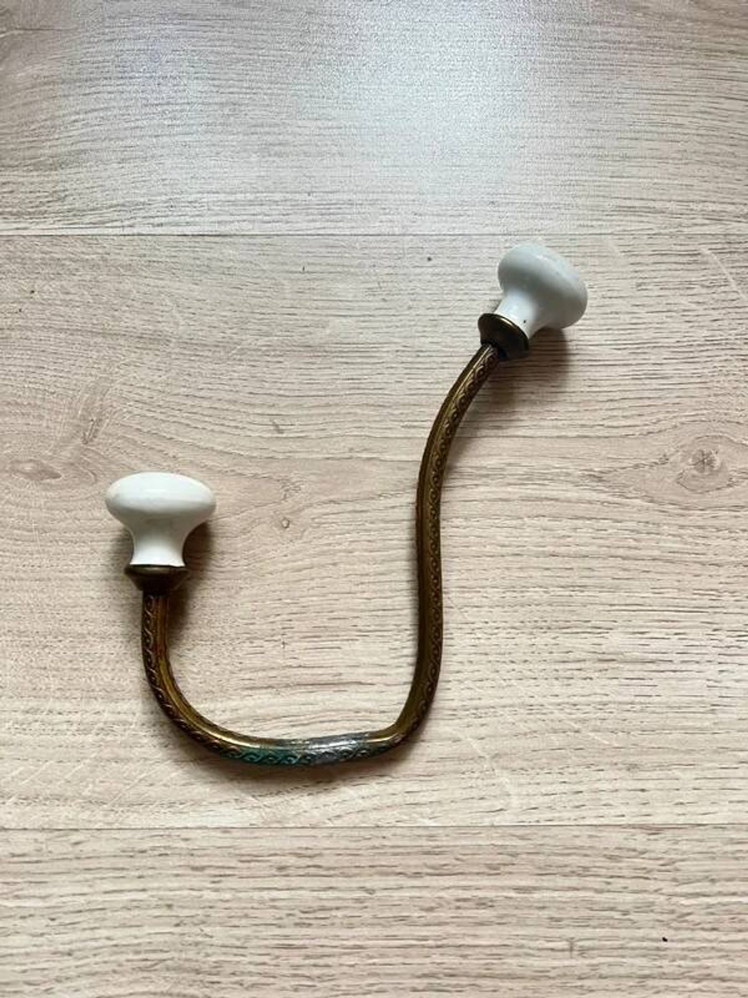 Vintage brass coat hook with ivory-style knob