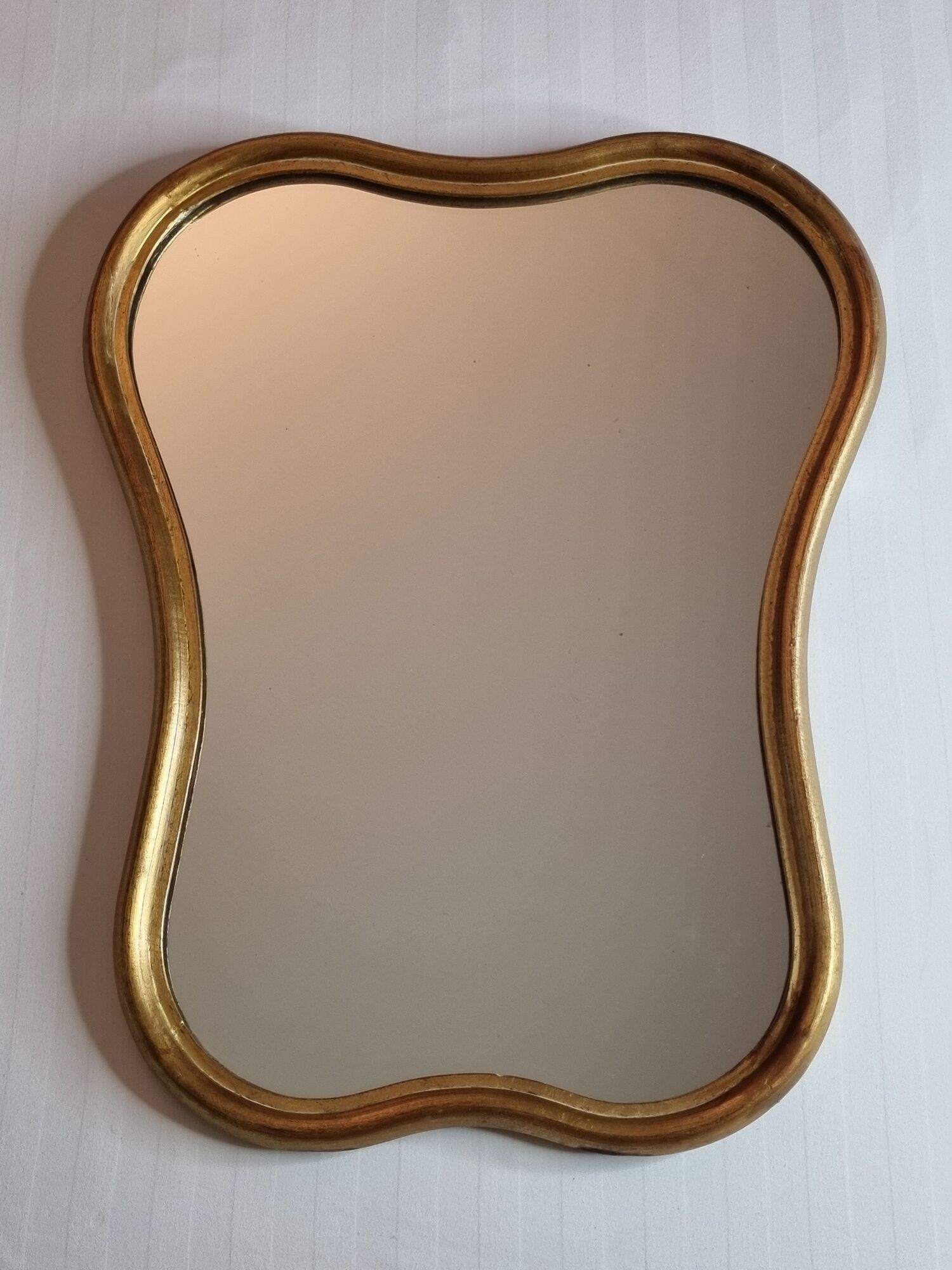 Vintage baroque style mirror, with curved frame in stucco and gilded wood 57 cm