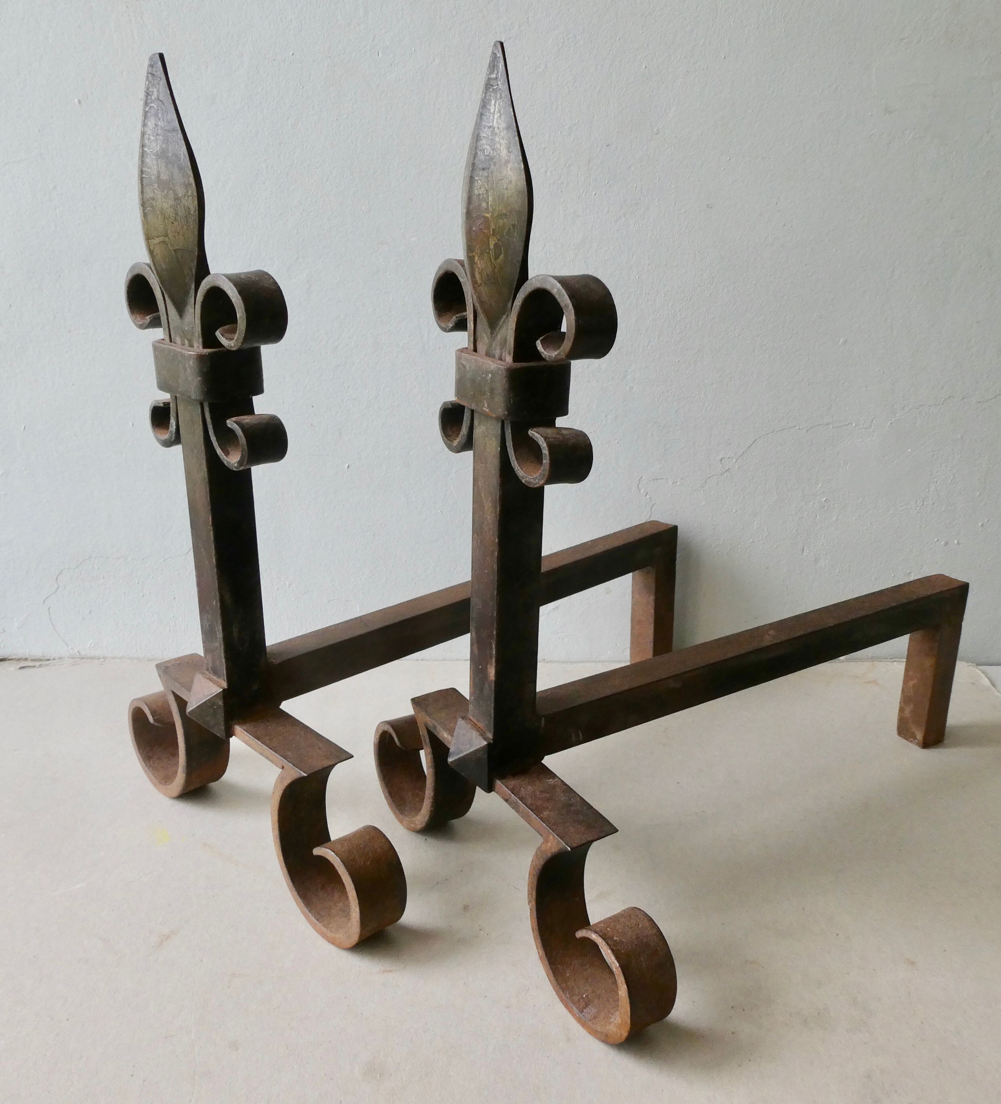 Pair of cast iron and beaten iron chenets, fleurs-de-lis