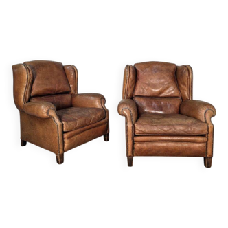Beautiful pair of wide leather club armchairs with ears in Havana colour.