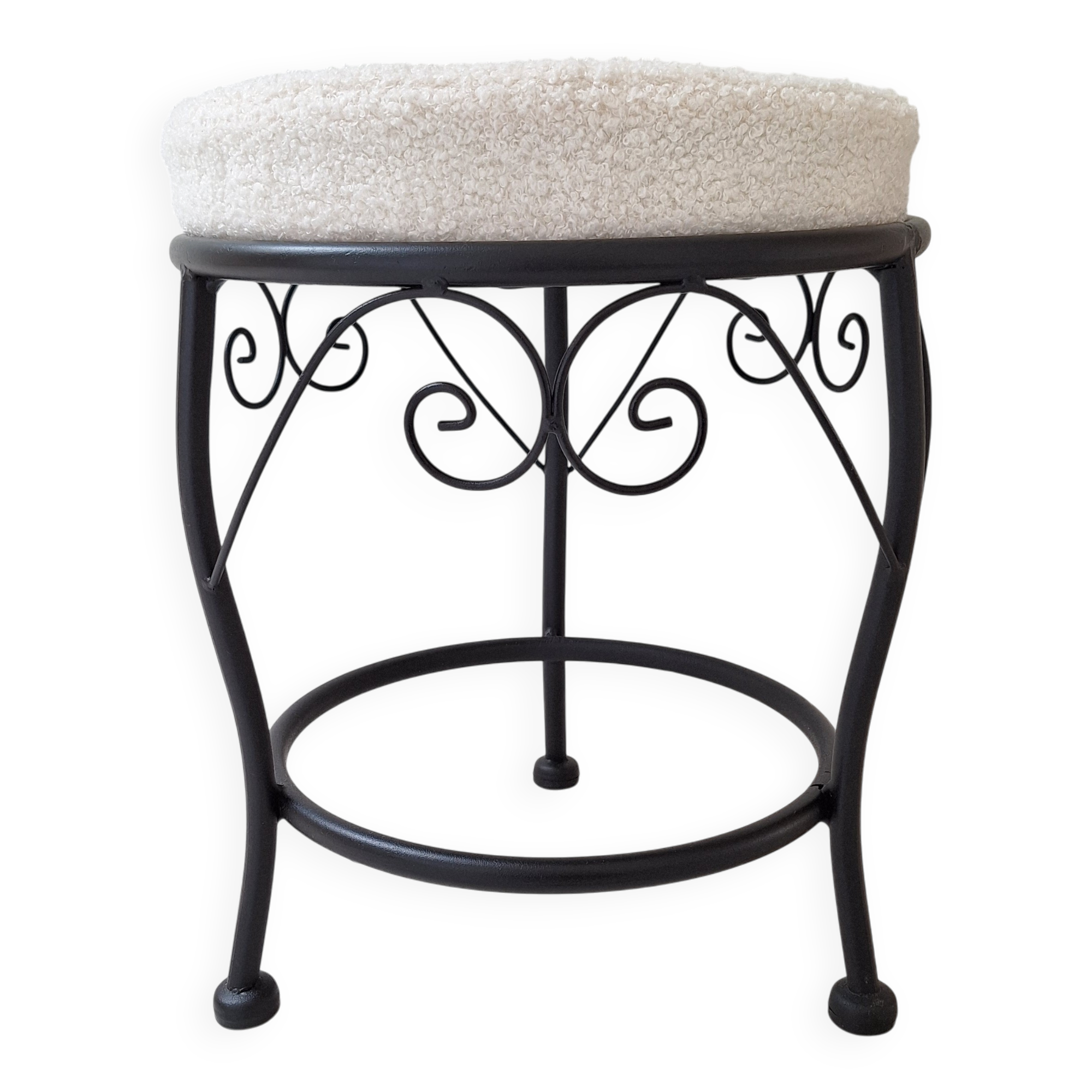 Black iron stool/pouf with its boucle fabric cushion.
