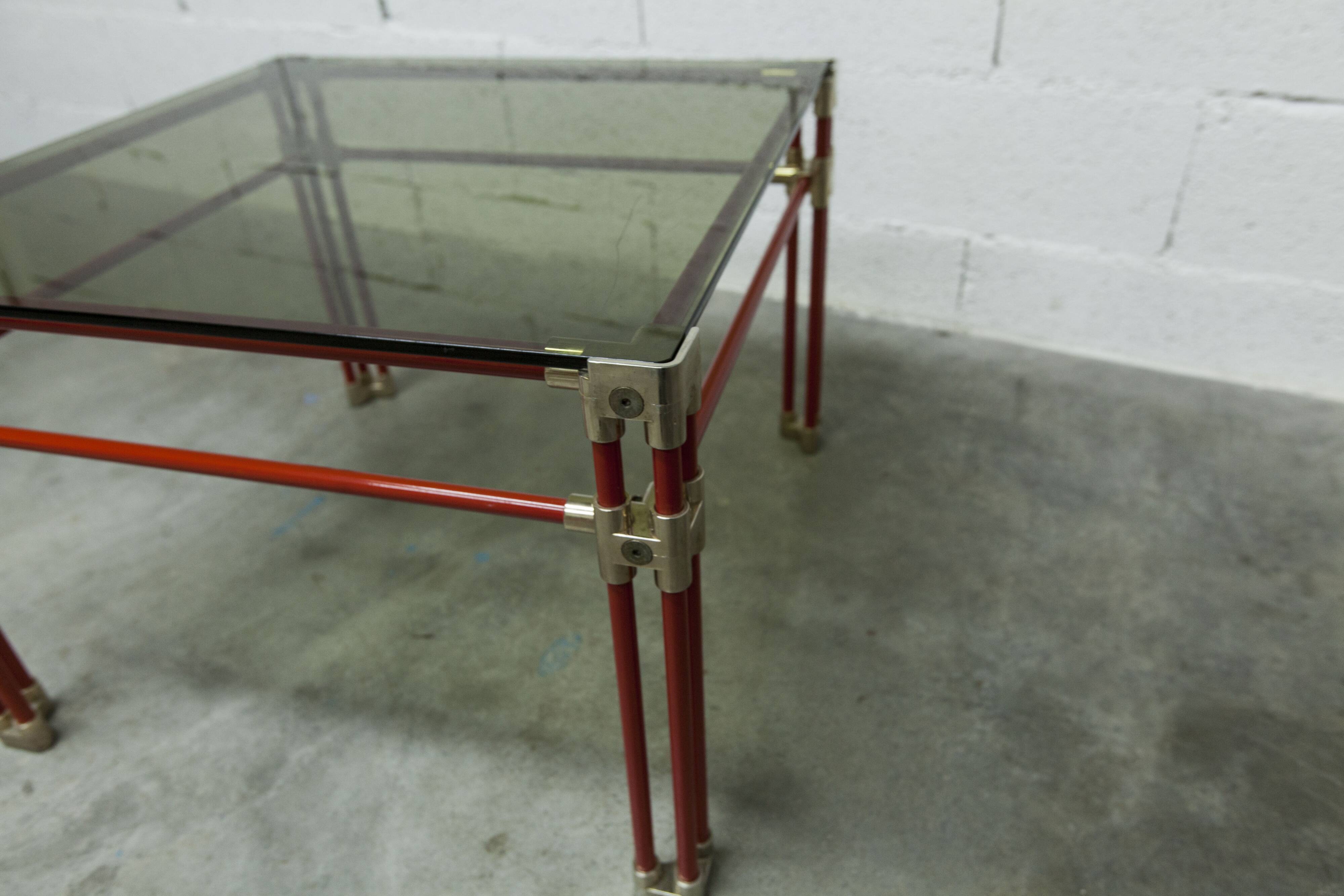 Postmodern Italian design coffee table in smoked glass with red steel structure