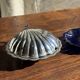 Vintage silver-plated shell butter dish with blue bowl.