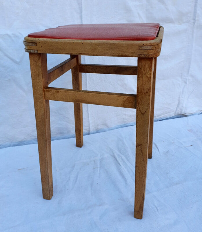 Vintage wooden stool and red skai seat