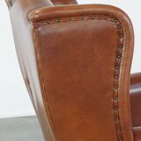 Cognac-colored leather wingback chair in English style