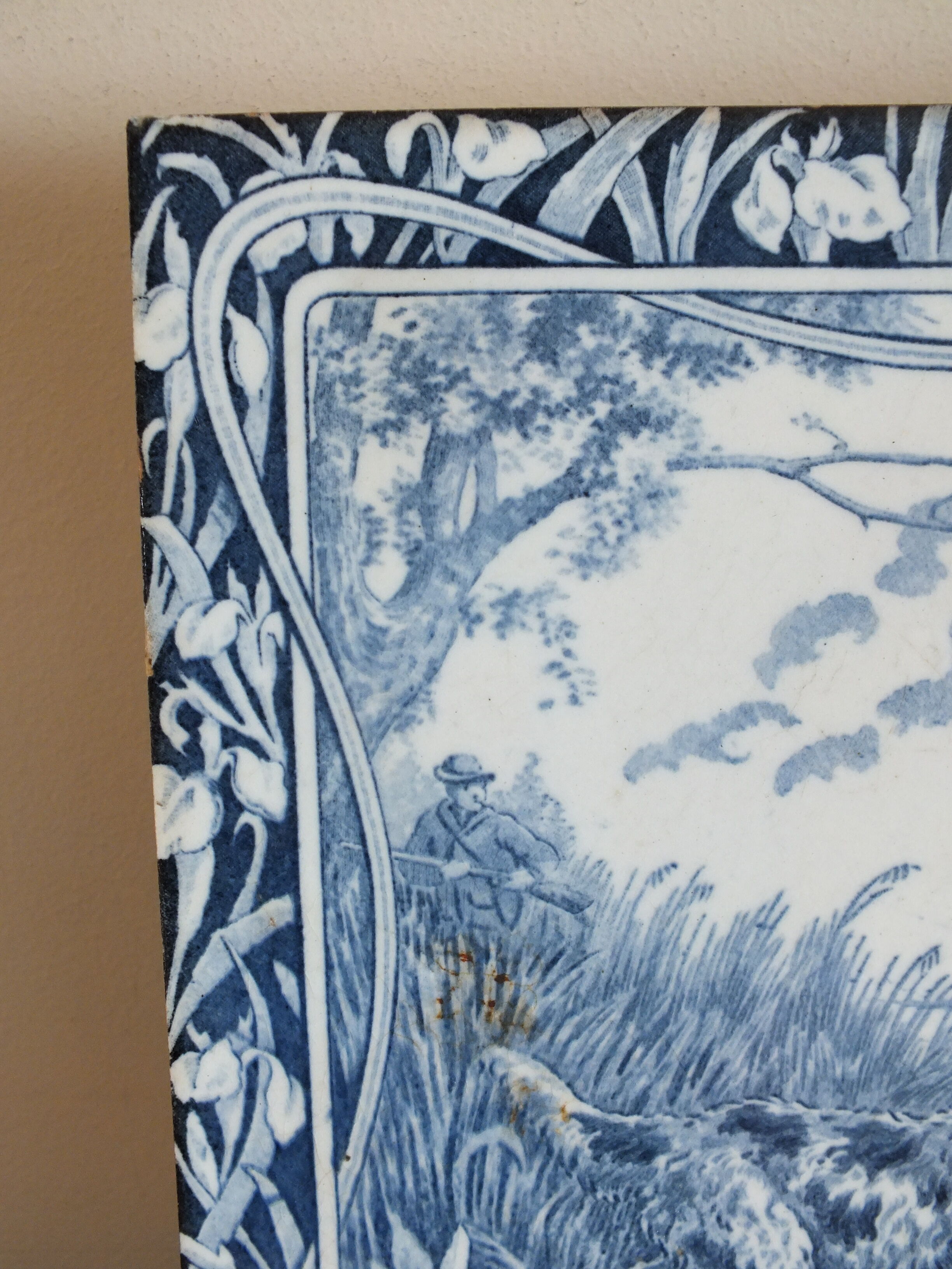 Old tile in Gien earthenware decoration hunting dog