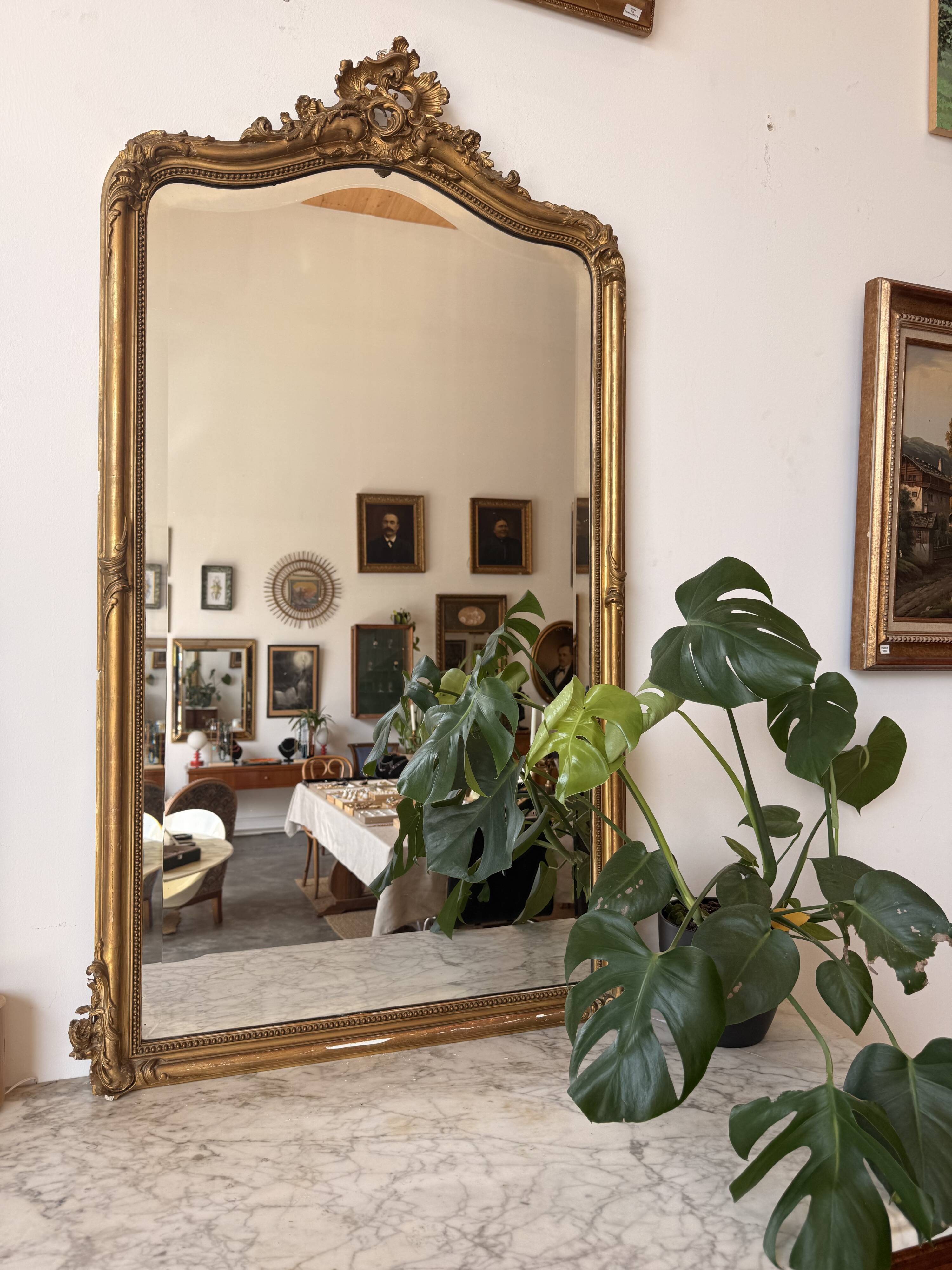 Large antique Louis XV style mirror in gilded wood.