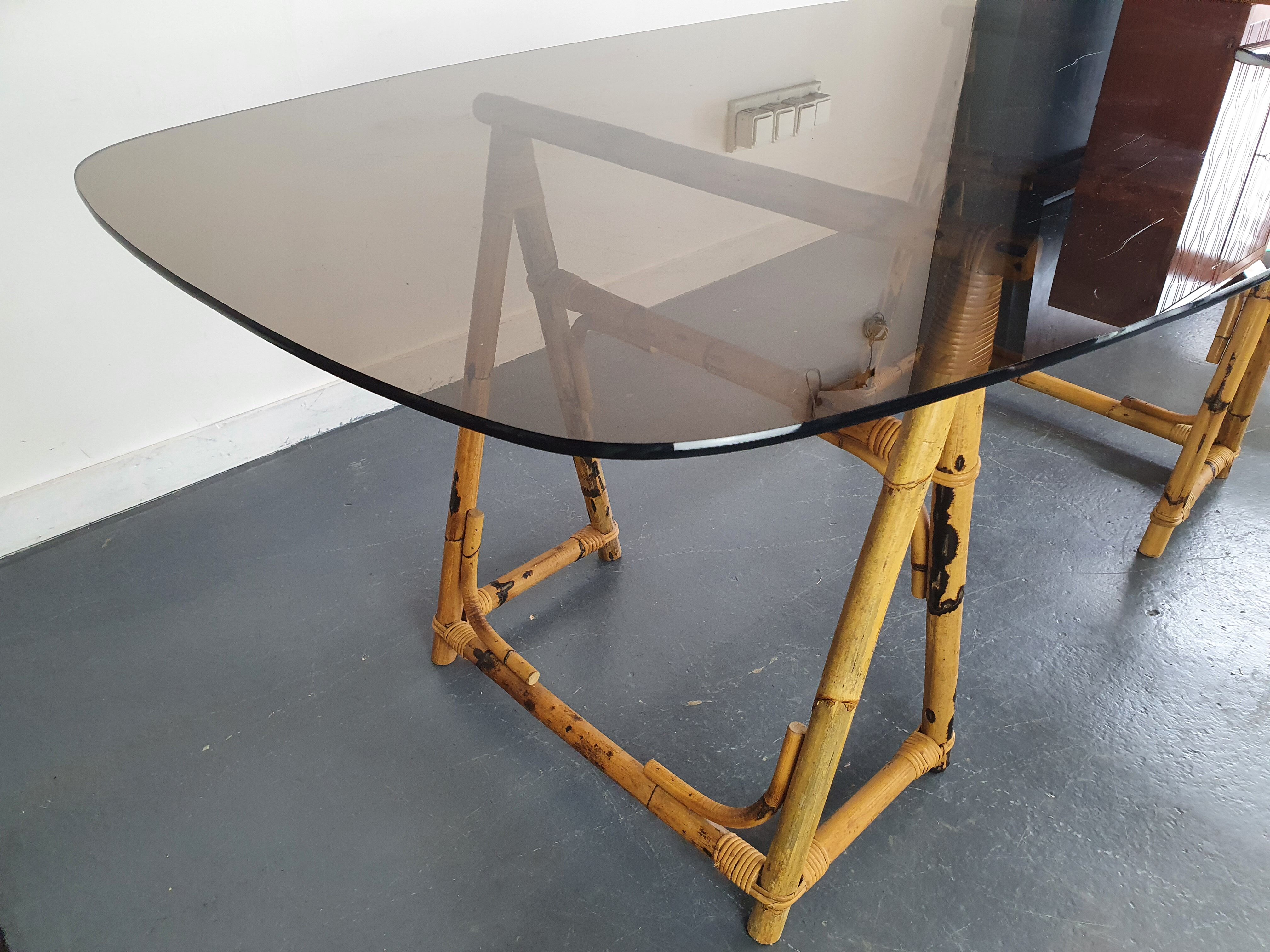 1970s dining table with bamboo trestle legs and smoked glass