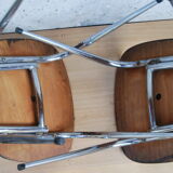 Pair of formica chairs with chrome metal backs in the shape of a lyre.