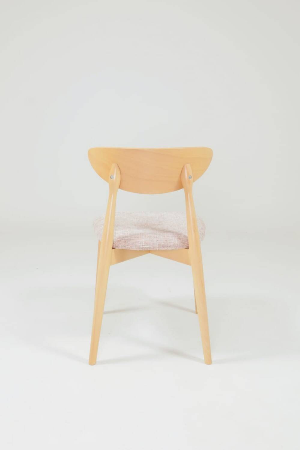 Set of 6 pale pink dining chairs in natural wood.