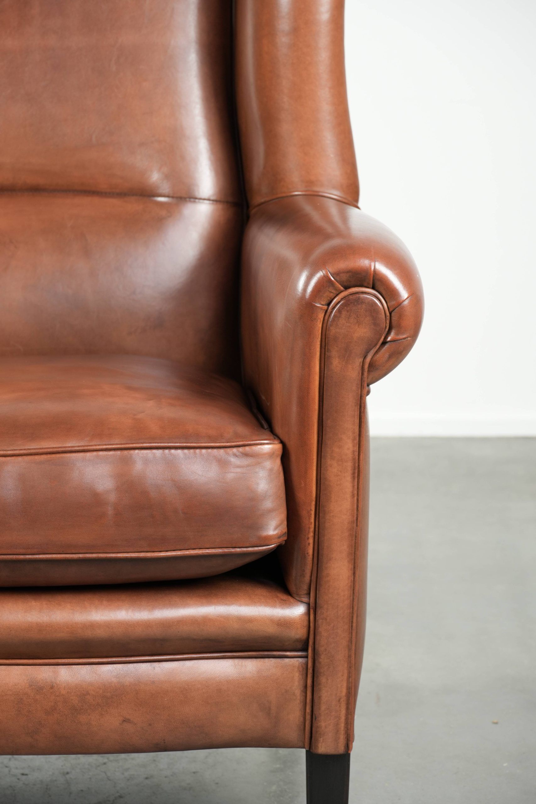 Large sheepskin wingback armchair in timeless English style