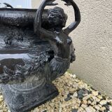 Cast iron vase decorated with mermaids.