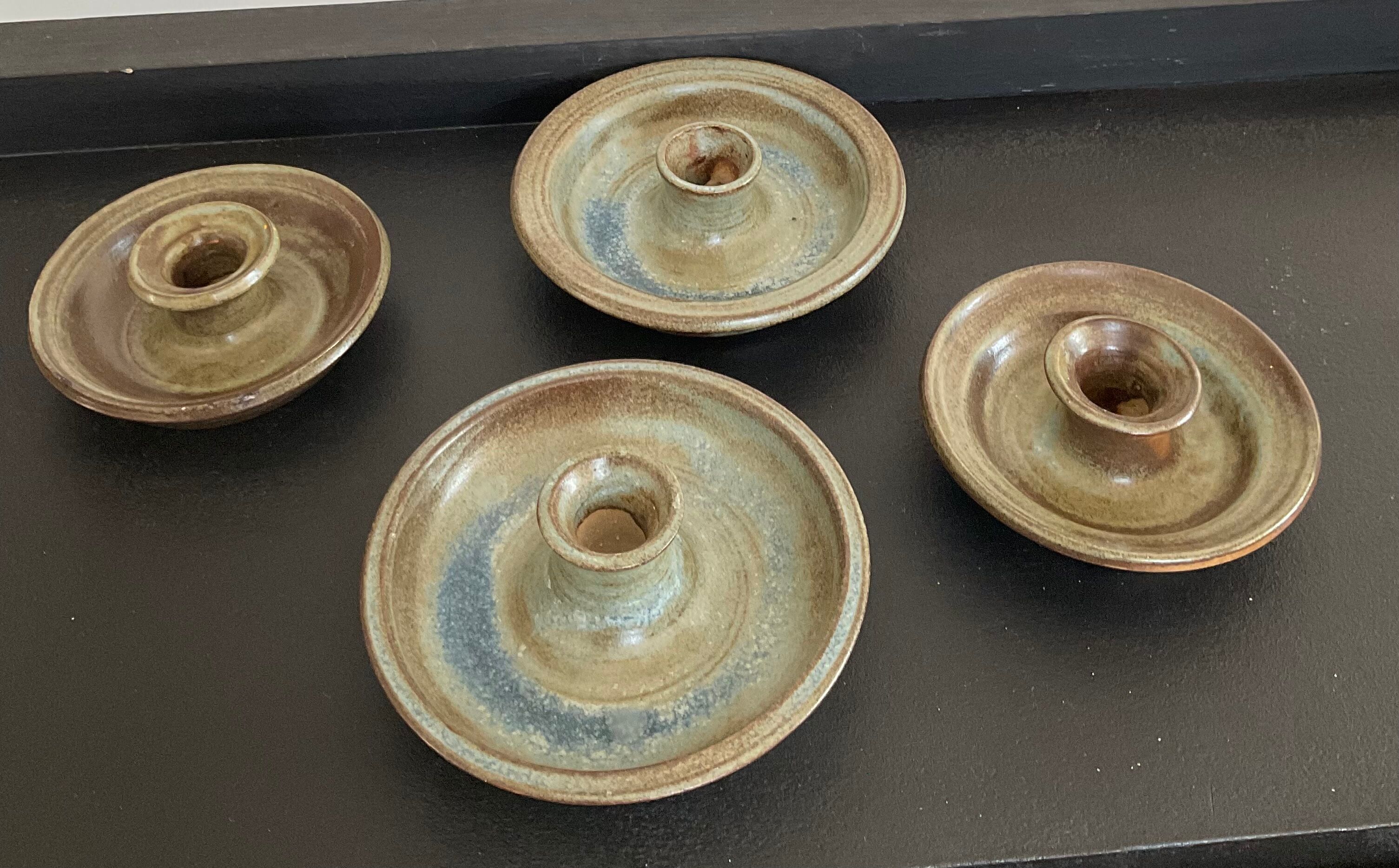 Series of 4 vintage stoneware candle holders