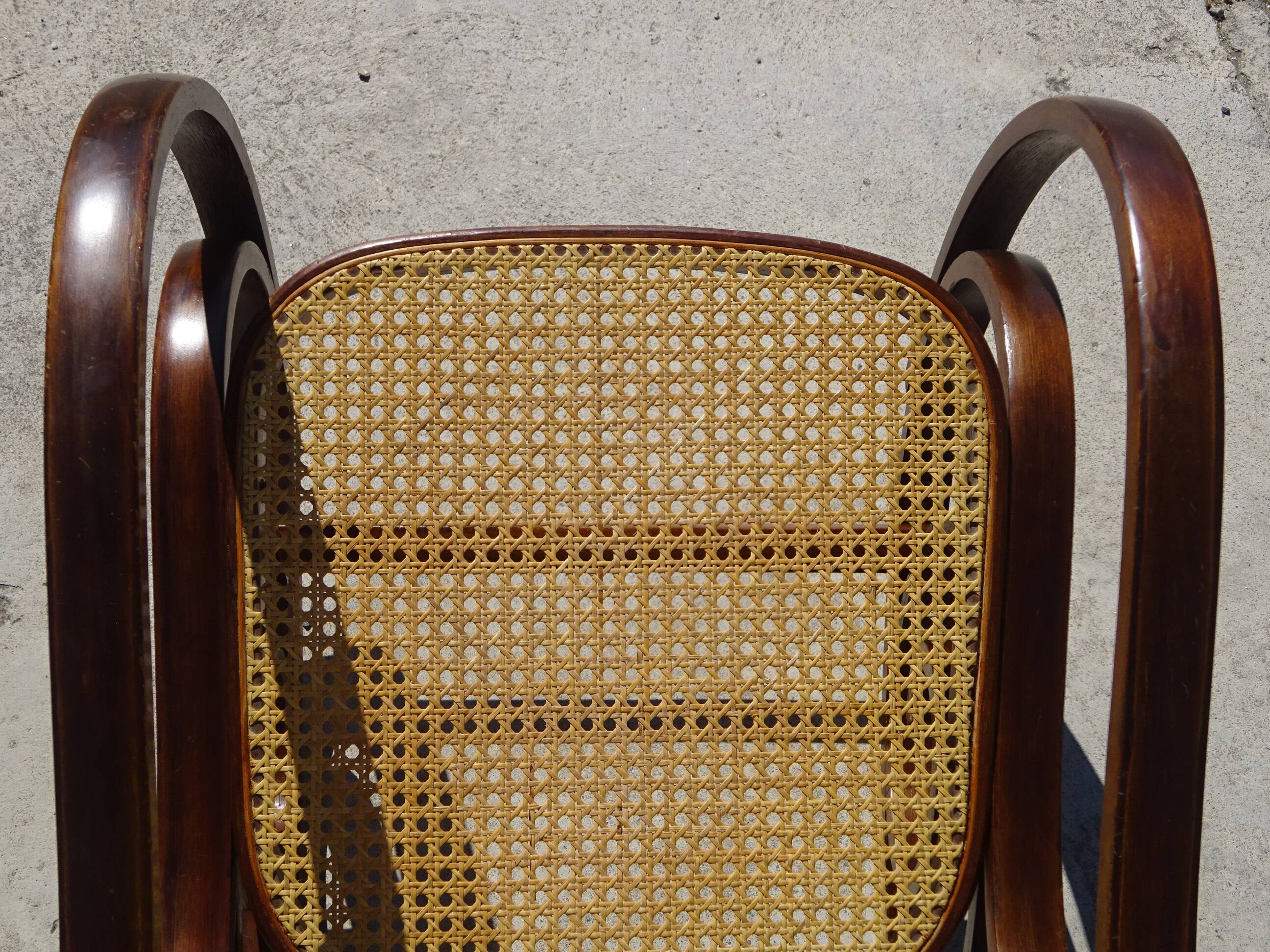 Vintage wooden rocking chair with caning