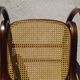 Vintage wooden rocking chair with caning