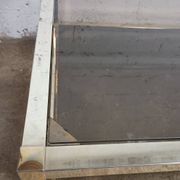 1970s coffee table in brass with a double smoked glass top.