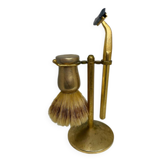 Old badger and razor set on gold metal stand