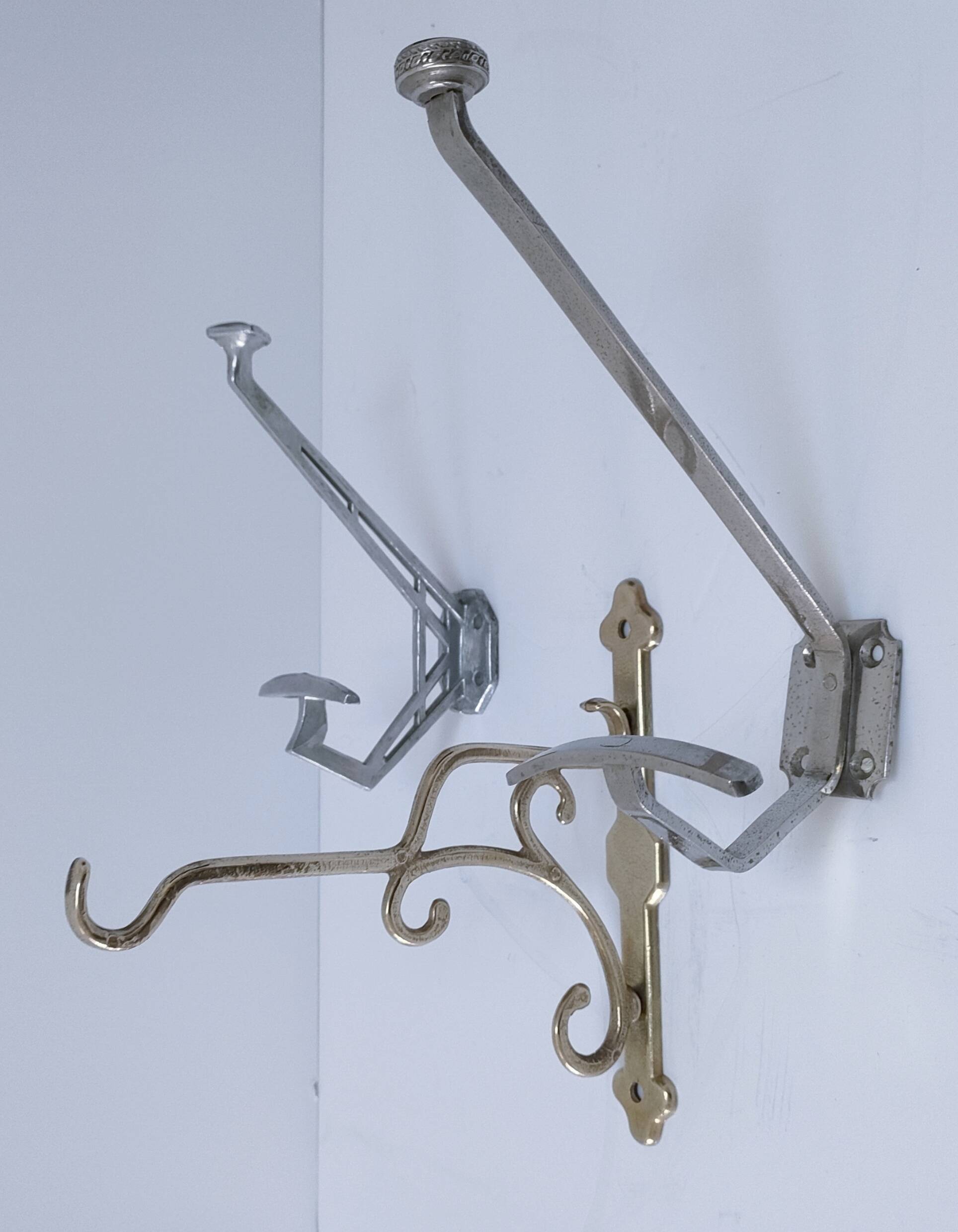 Three brass, chrome, aluminum hooks, early 20th century