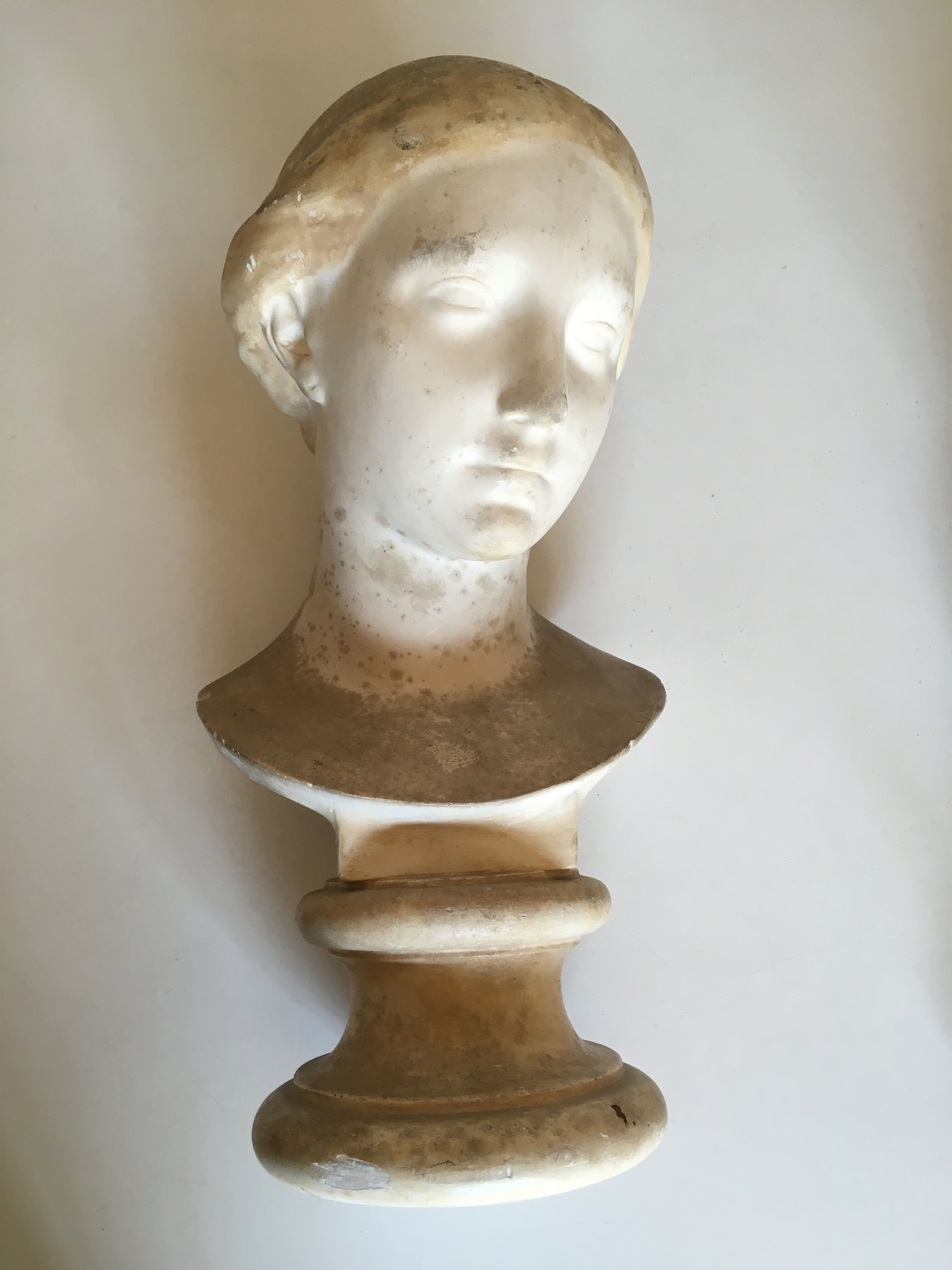 Former girl bust end 19th in plaster cast on its base