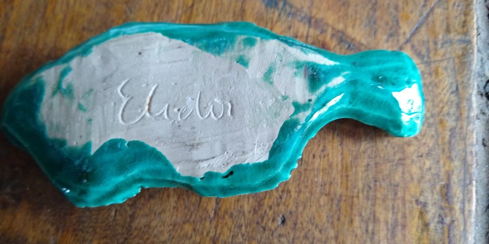 9 knife holders in green earthenware in the shape of a fish