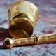 Mortar and its brass pestle with oriental gold and silver motifs