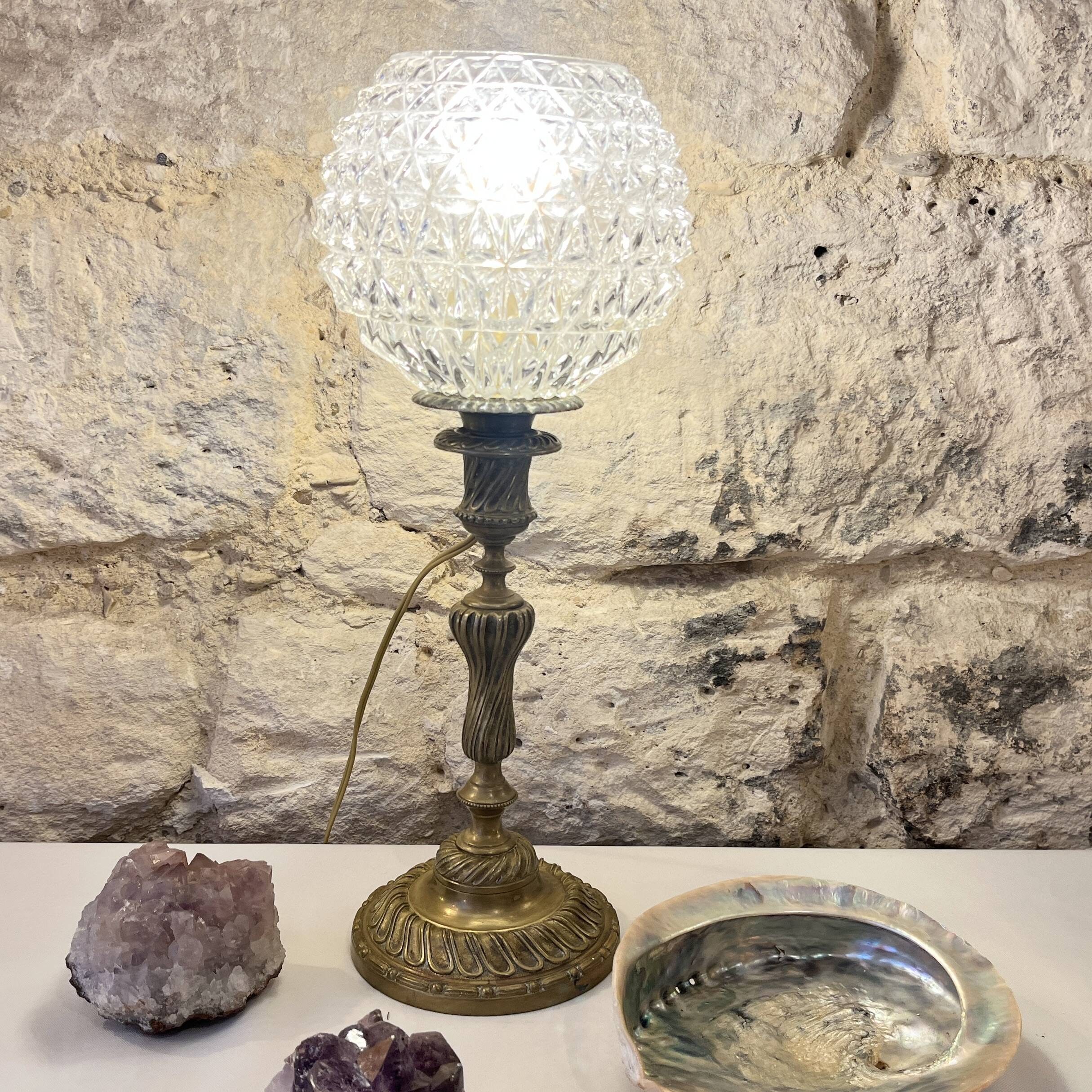 Antique brass foot lamp with glass globe and diamond point.