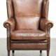 Subtle dark brown sheepskin wingback armchair with a timeless look subtle