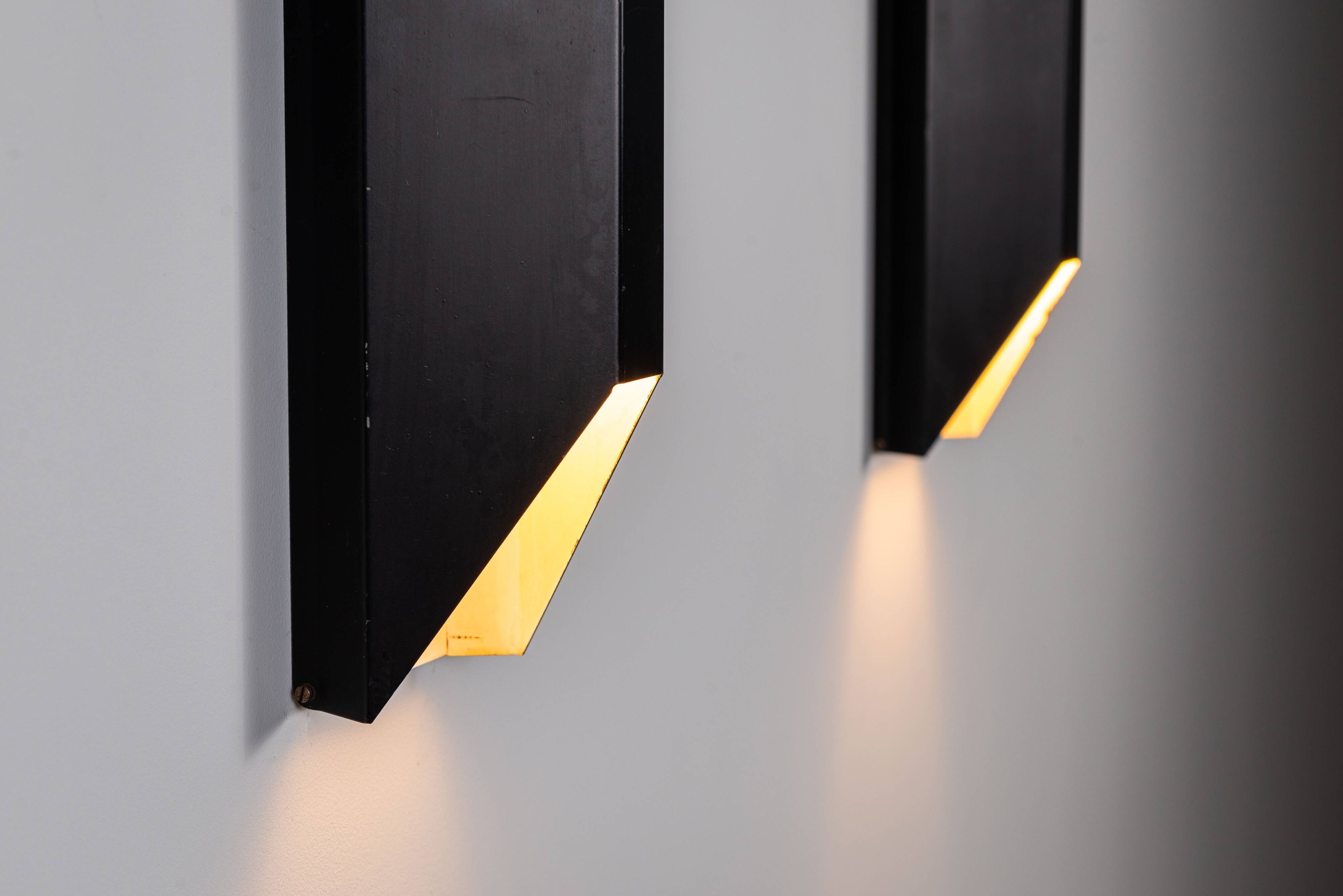 Architectural pair of vintage black metal wall lamps with angular geometric