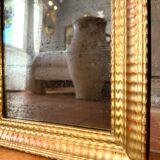 Antique gilded mirror from the Directoire period, 19th century.