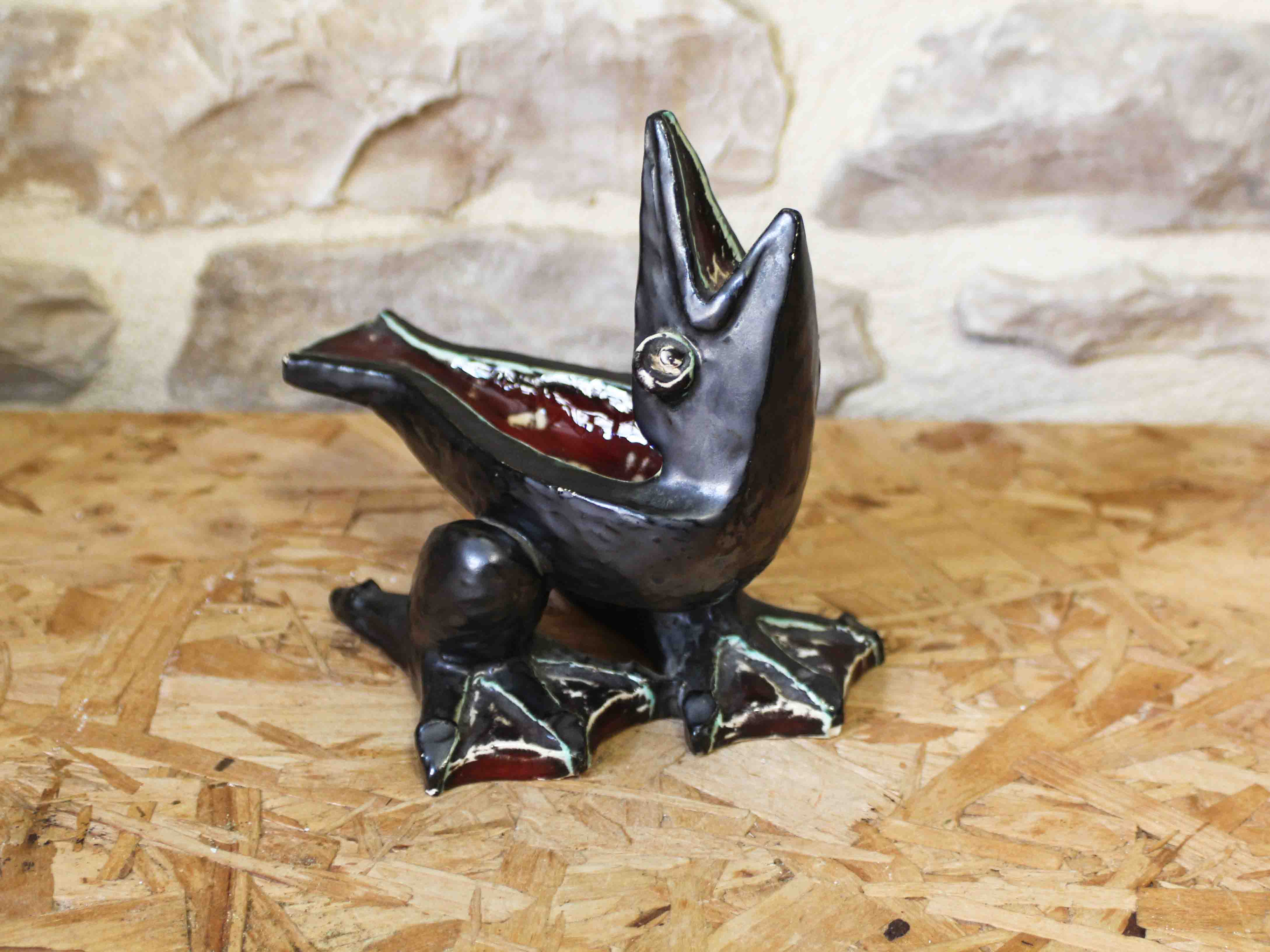 Glazed ceramic ashtray in the shape of a bird.