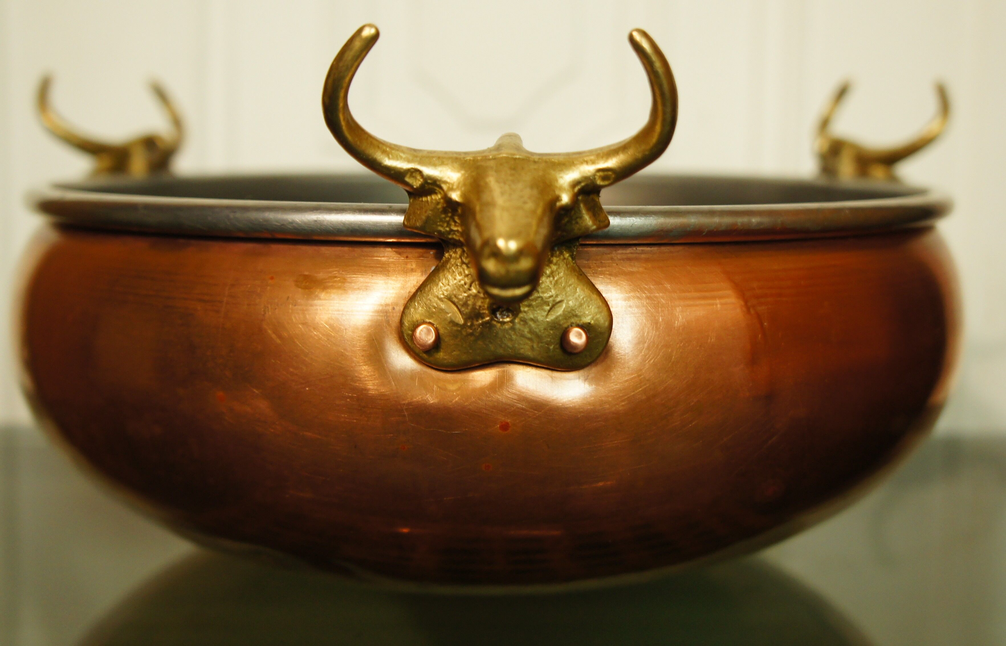 Copper cauldron with golden bronze bull heads
