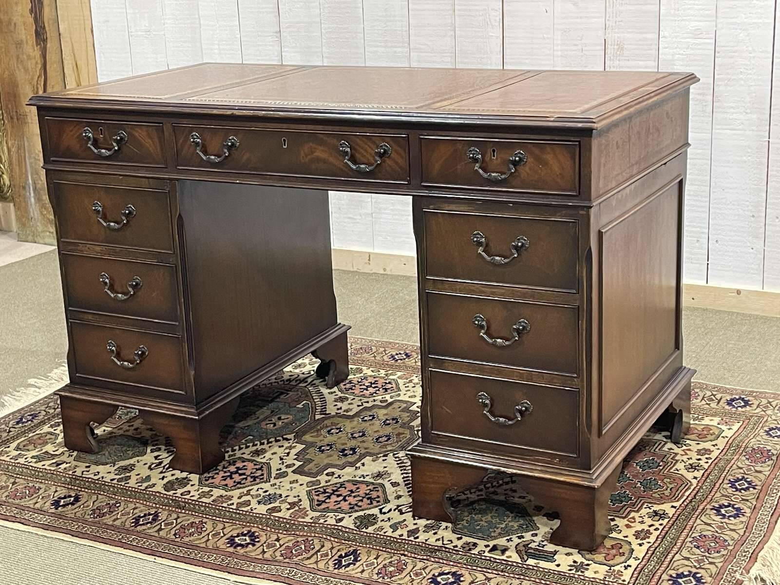 English mahogany pedestal desk with leather top from the 1950s
