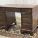 English mahogany pedestal desk with leather top from the 1950s