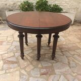 Oval table with extensions in massive mahogany napoleon III era.