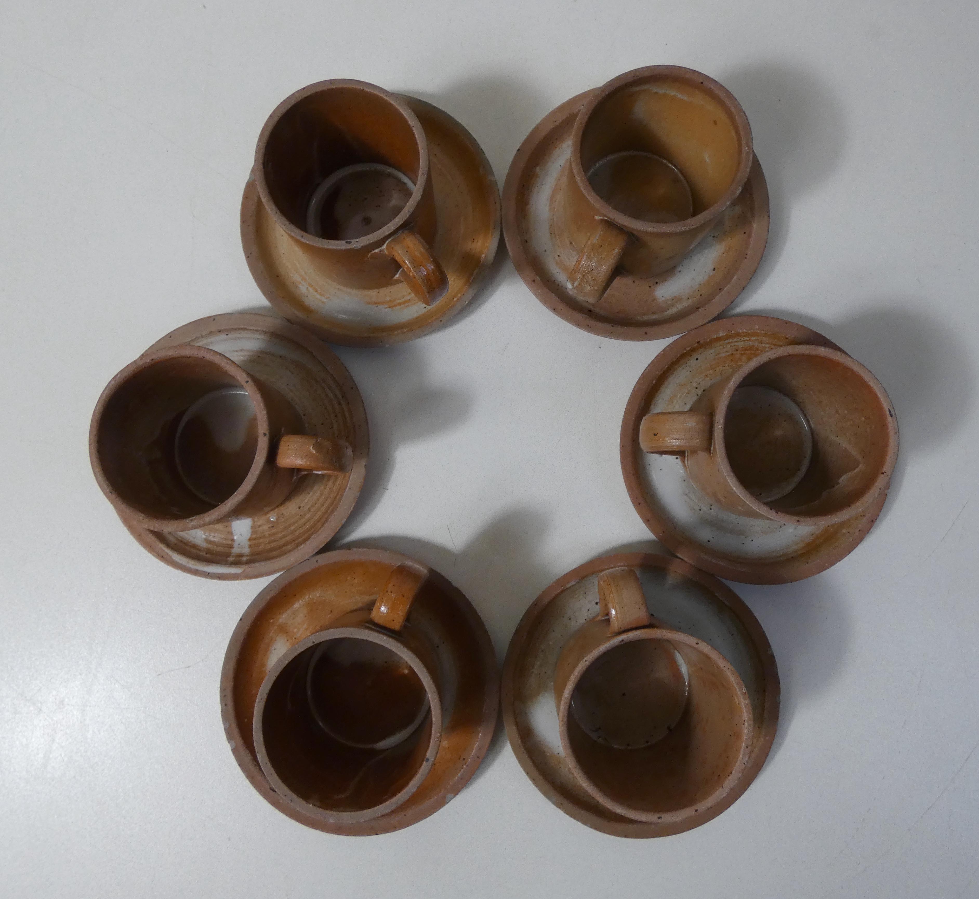 6 stoneware cups and saucers