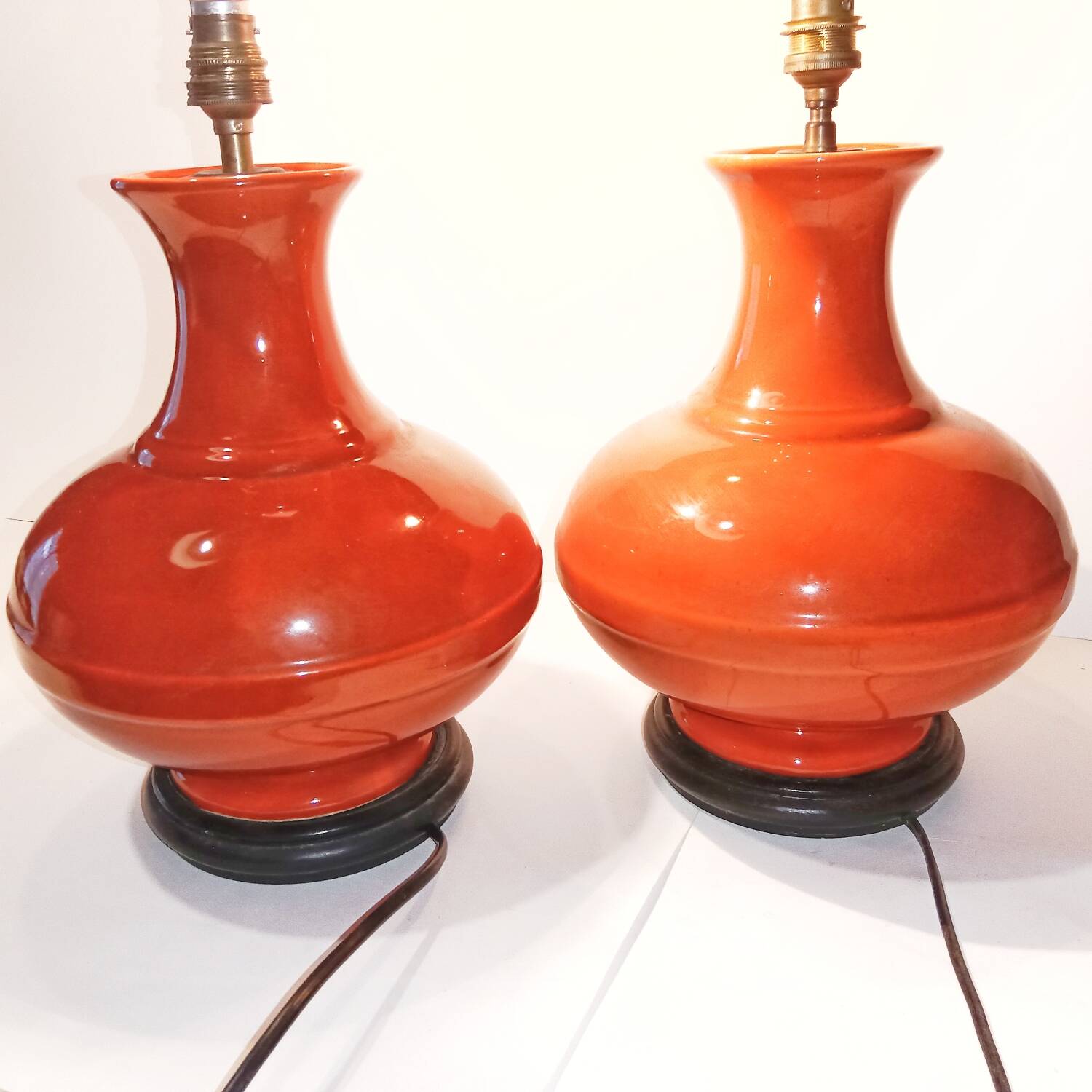 Pair of ceramic lamp bases in the shape of orange gourds.