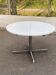 White dining table with a central pedestal, extendable, from the 1970s.
