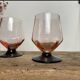 4 pink glasses with black stems