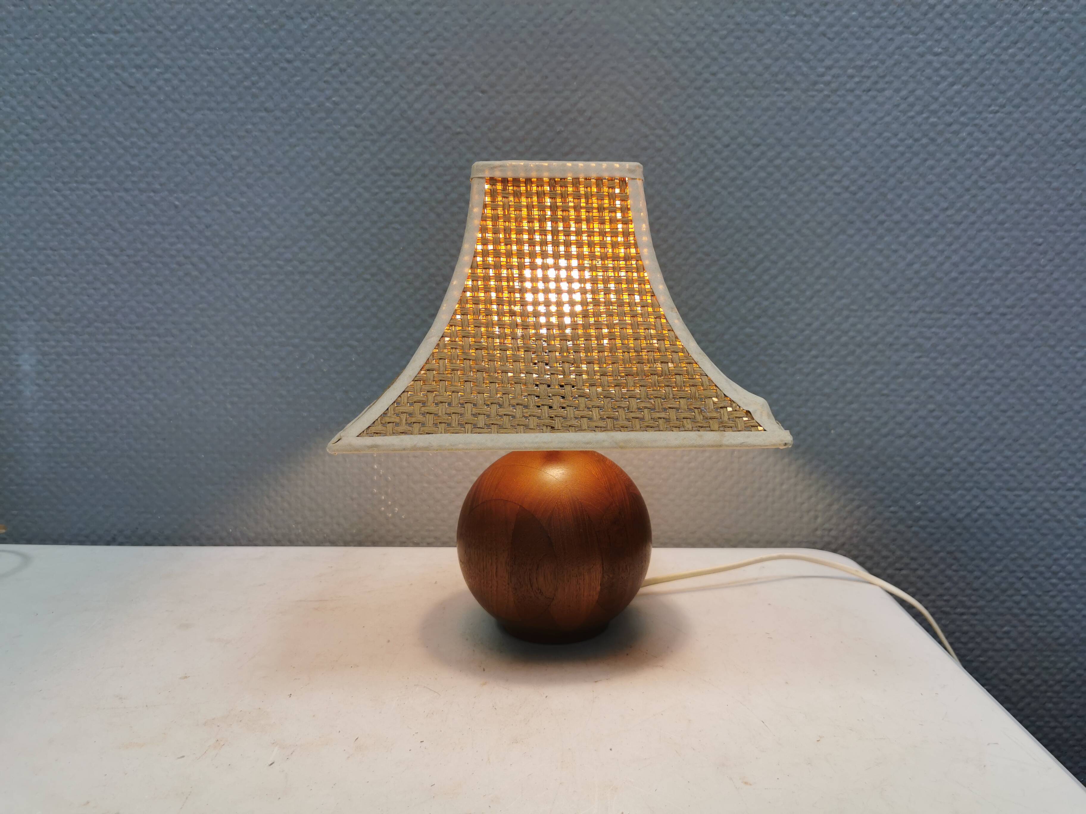 Very rare table lamp in turned teak wood with original braided shade. 1970s