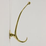 Two curved wall coat racks in brass by Franz Hagenauer, Vienna, mid-20th century, 1950s.