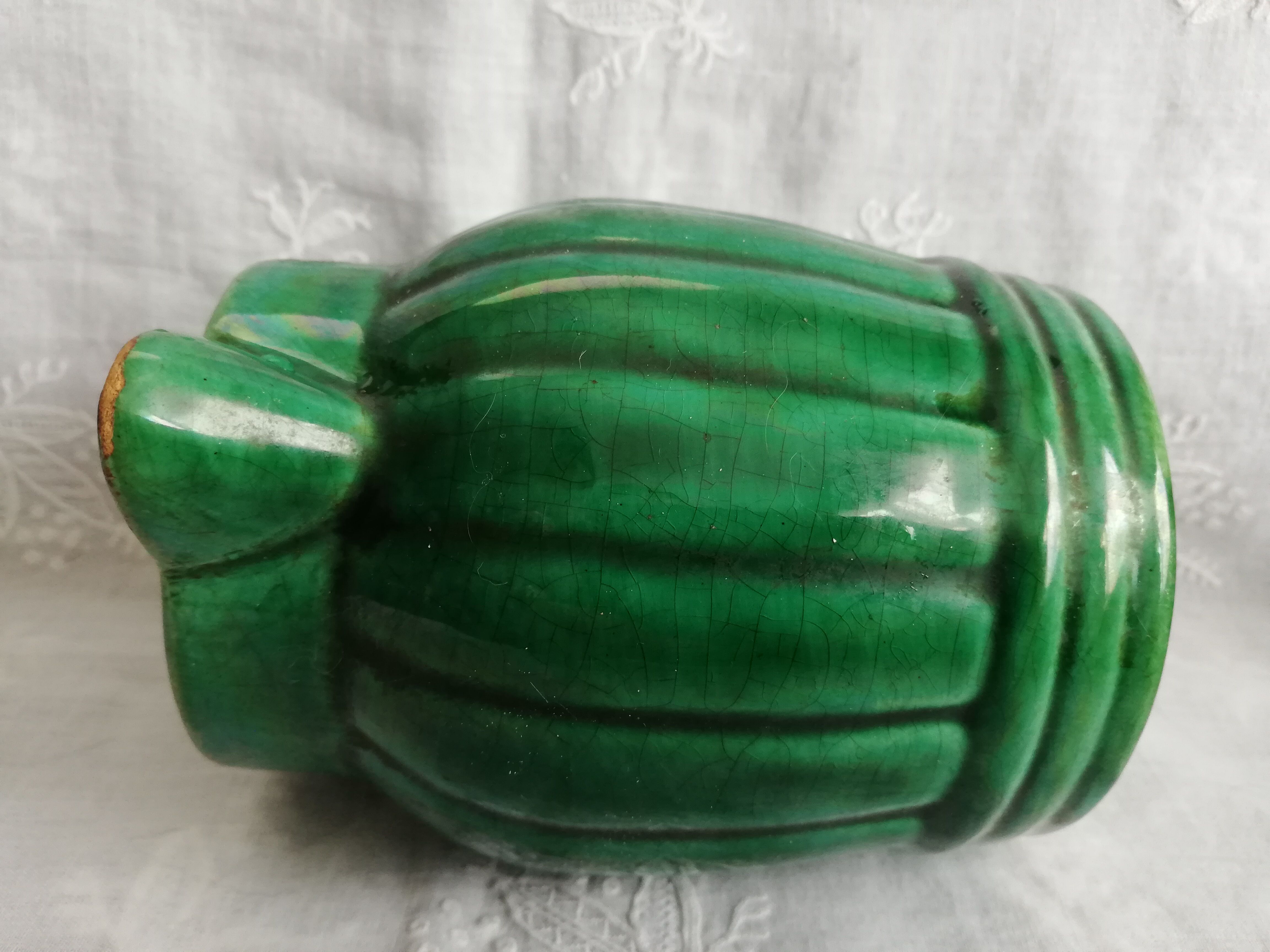 Old green pitcher in dabbling