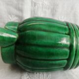 Old green pitcher in dabbling