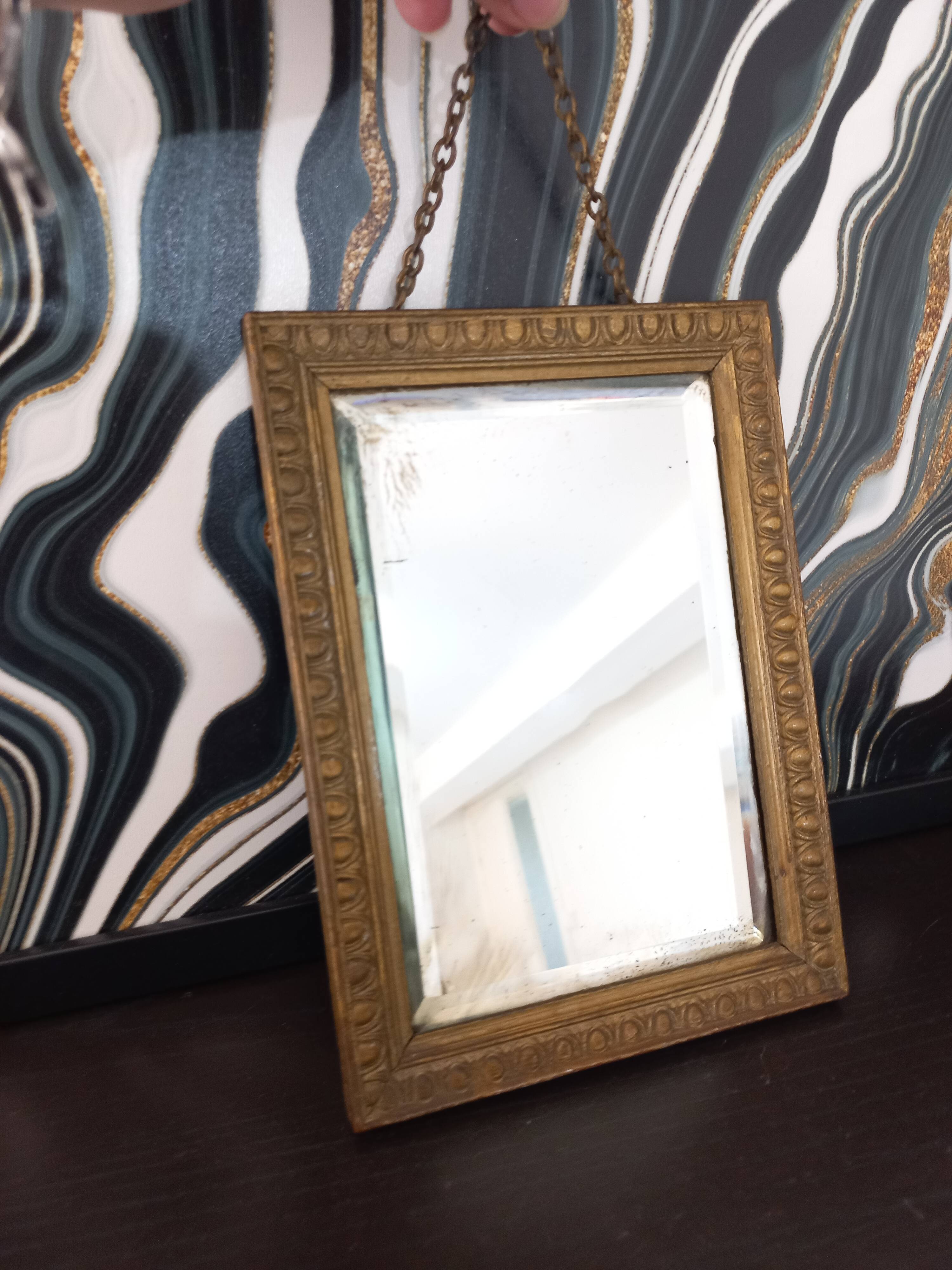 Small vintage mirror in gilded wood, bevelled glass with chain.