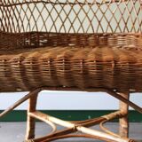 Woven rattan armchair with armrests.