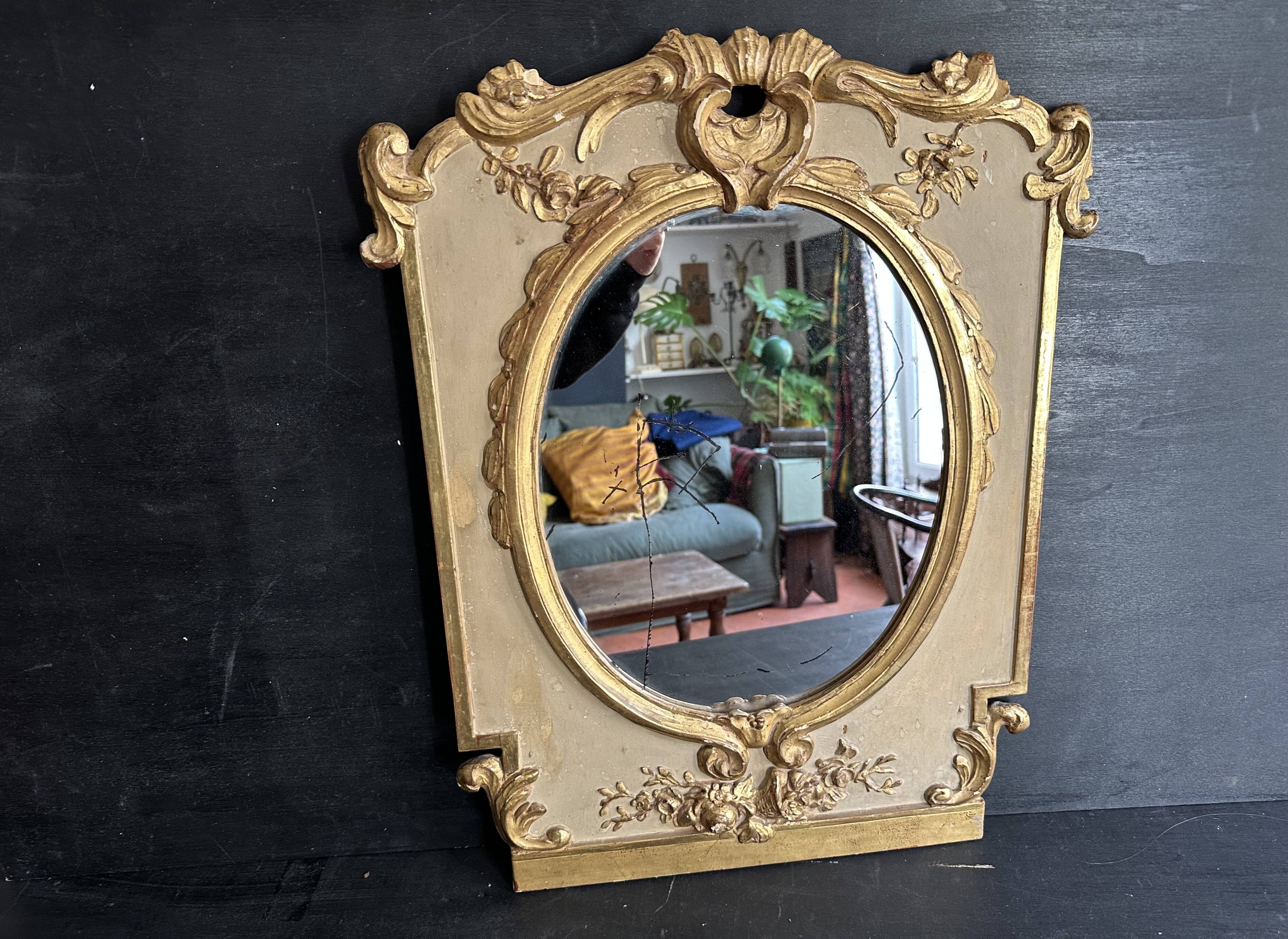 Napoleon III mirror in carved gilded wood, oval mercury glass.