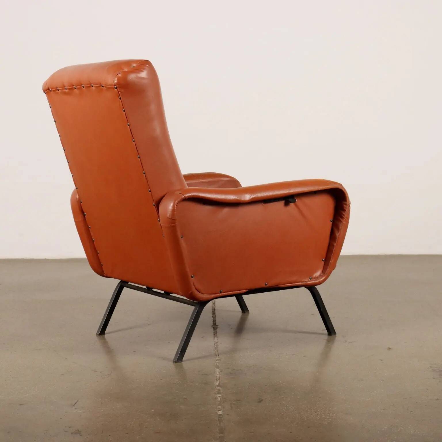 Vintage armchair from the 1970s in foam, faux leather, and metal.