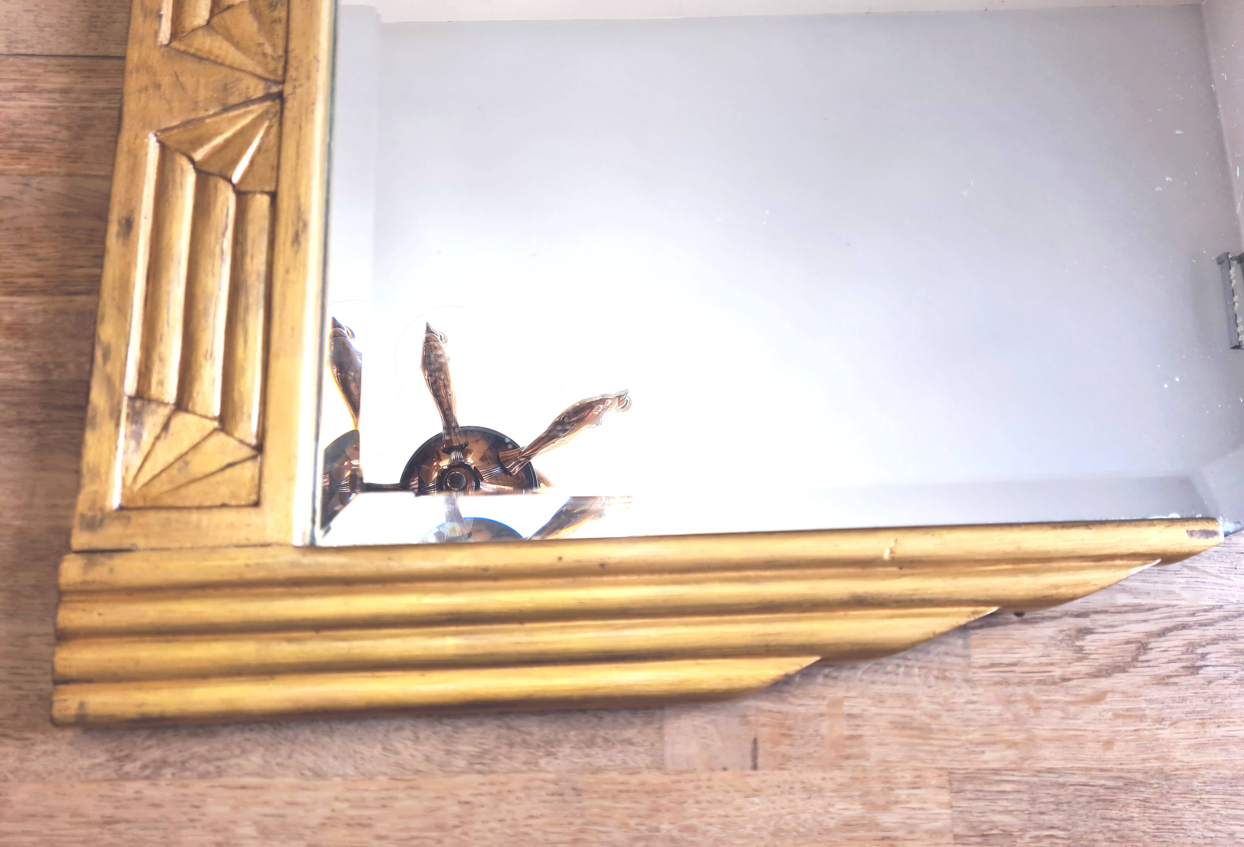 Antique Art Deco mercury mirror, in carved wood with gold leaf.