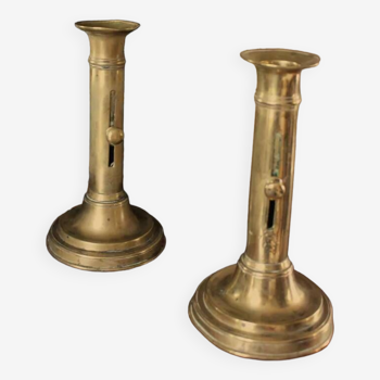 Pair of brass torch candle holders with pushers