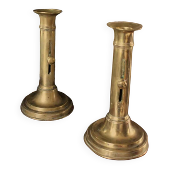 Pair of brass torch candle holders with pushers